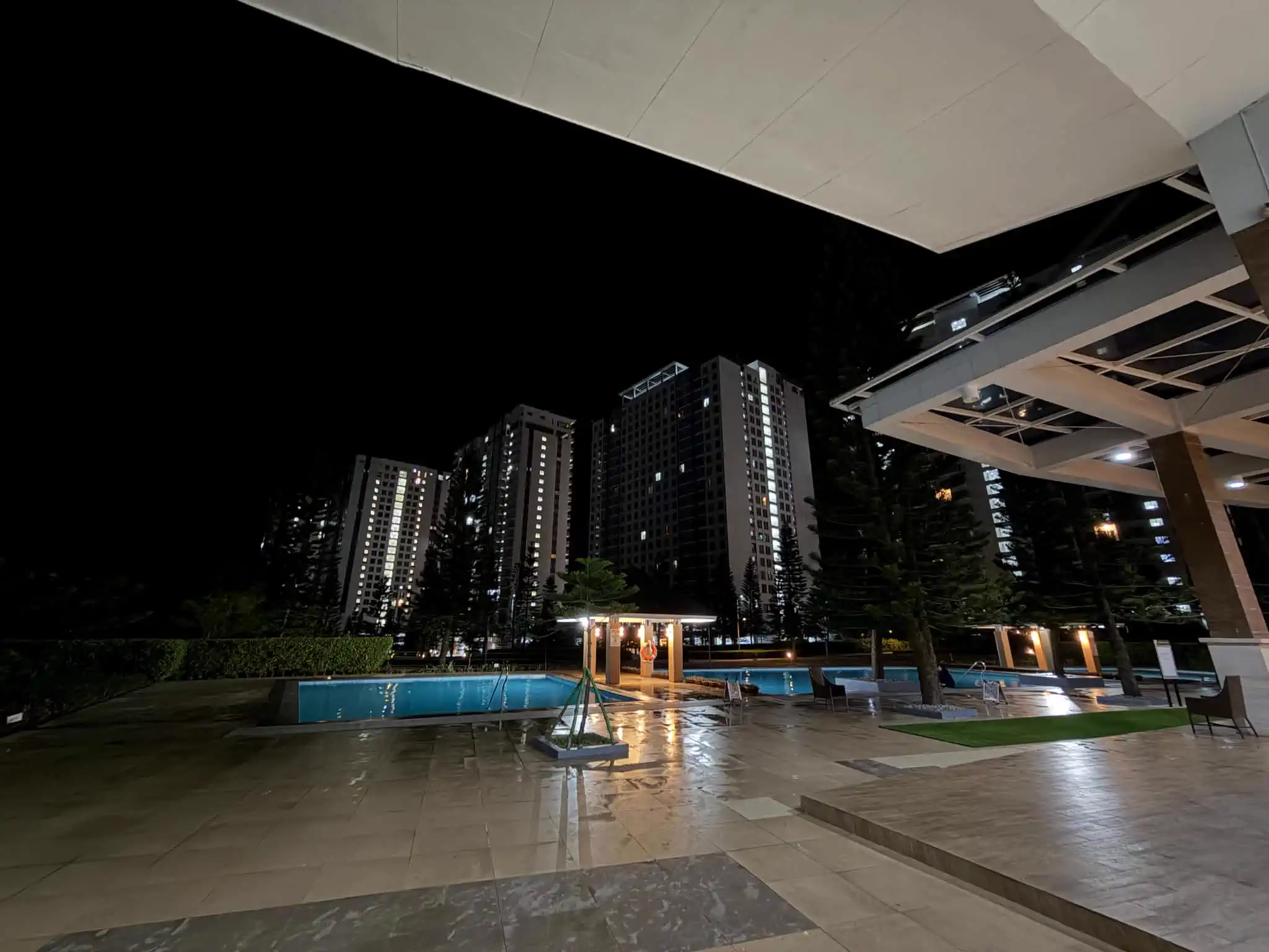 Night view of the swimming pools and Wind Residences buildings